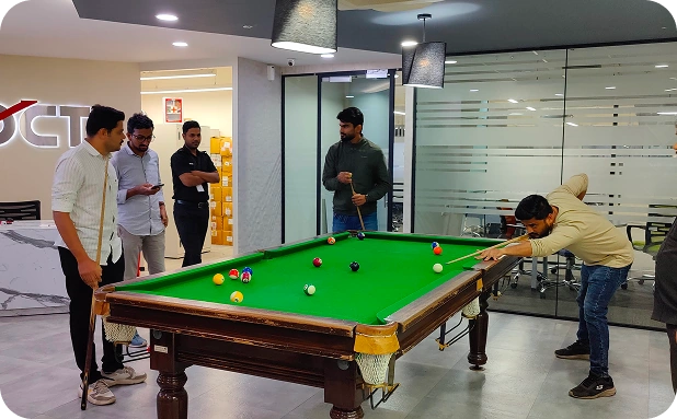 DCT colleagues playing pool in the office lounge